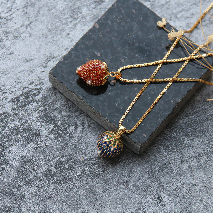Set aus zwei Erdbeer-Halsketten in Blau und Rot mit goldenen Ketten – fruchtiger Halsschmuck im trendigen Design, ideal als Geschenk